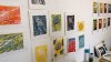 Colourful lino cut prints hanging on a wall